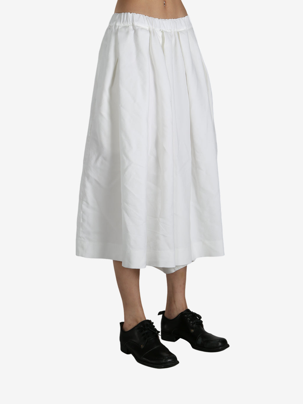 White pants worn by a person, showing the pants fit