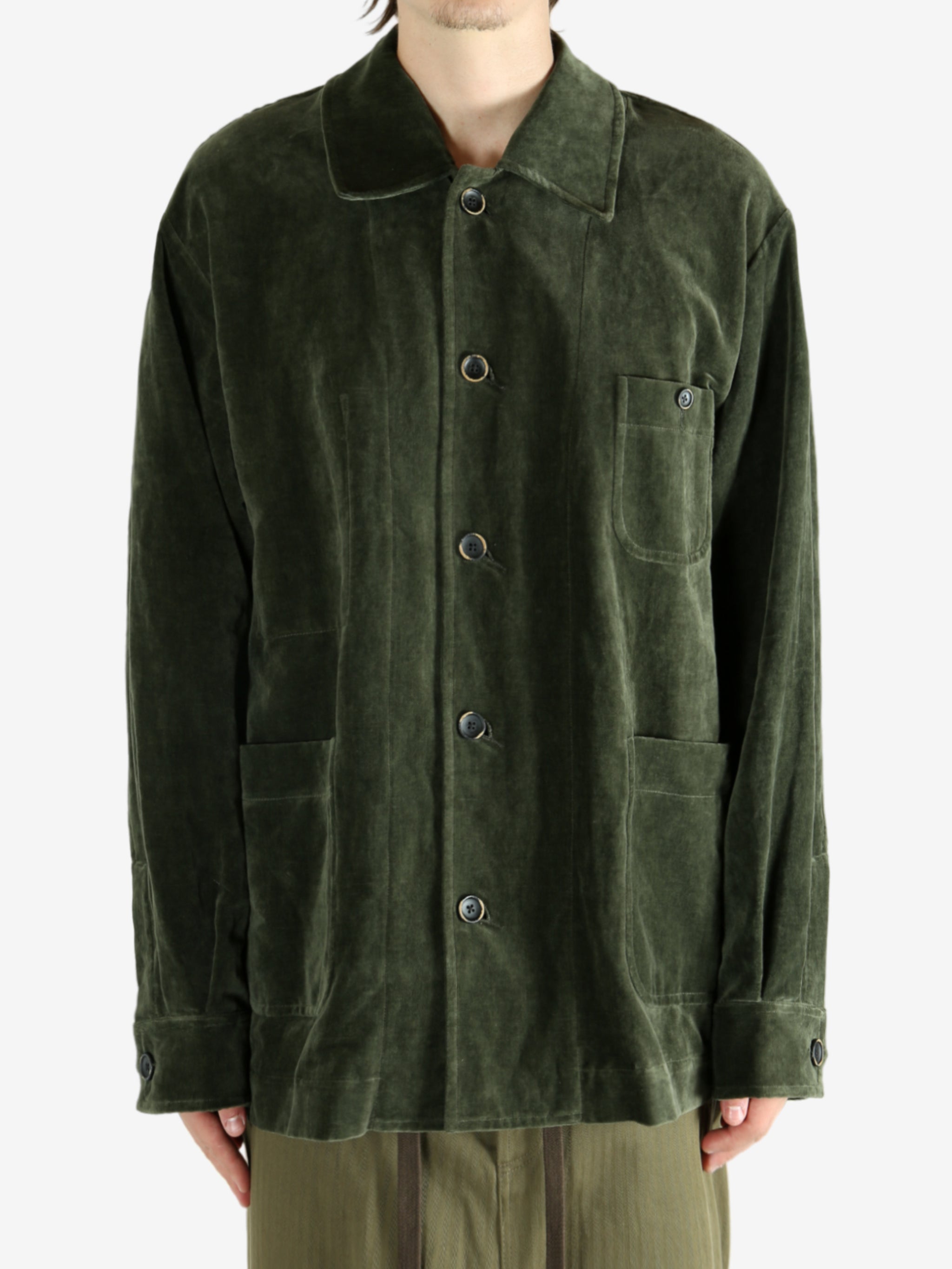 Green jacket worn by a person, showing the jacket's fit