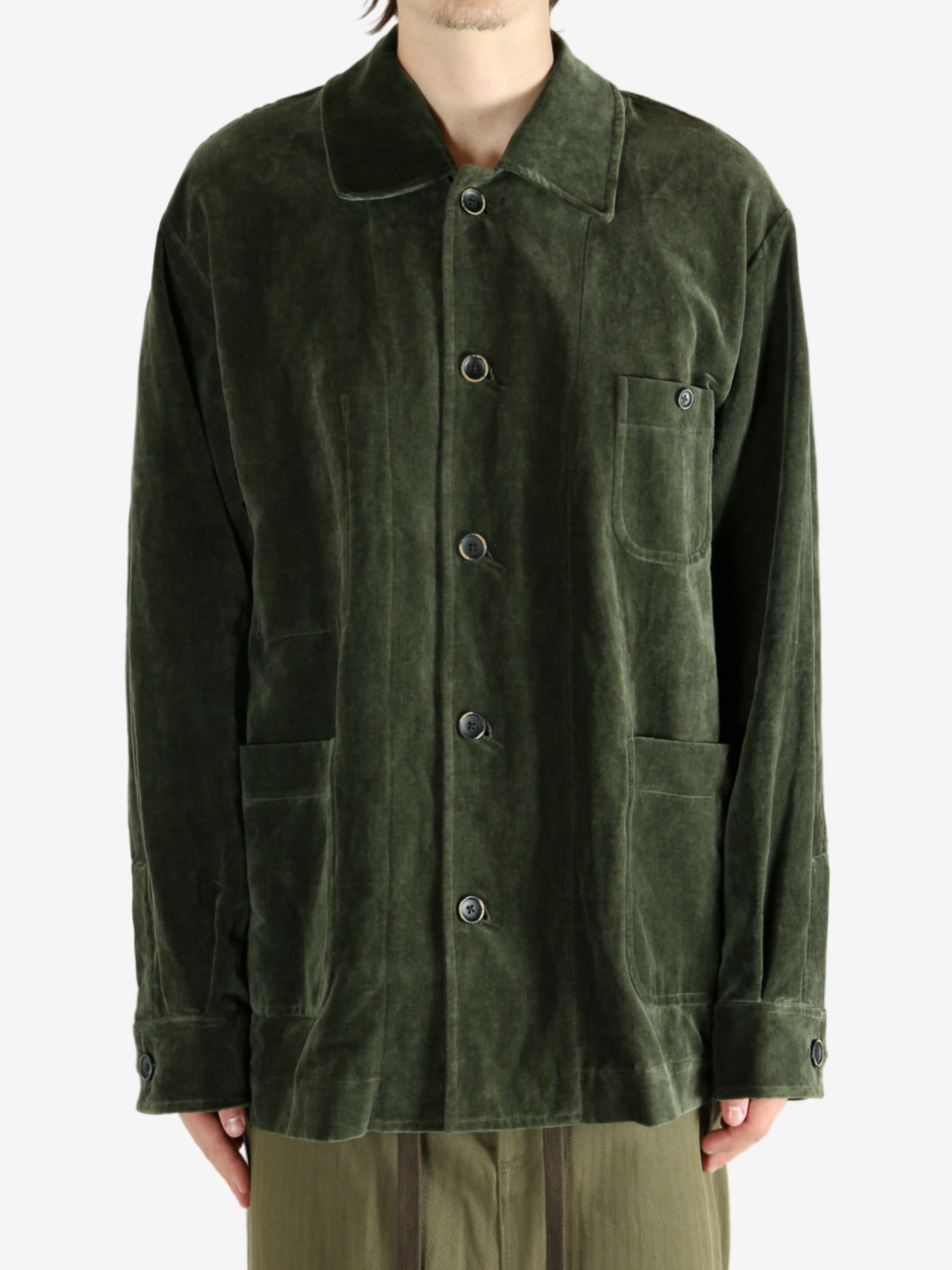 Green jacket worn by a person, showing the jacket's fit