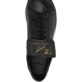 Close up of black shoes, showing texture of the rubber and calf leather fabric