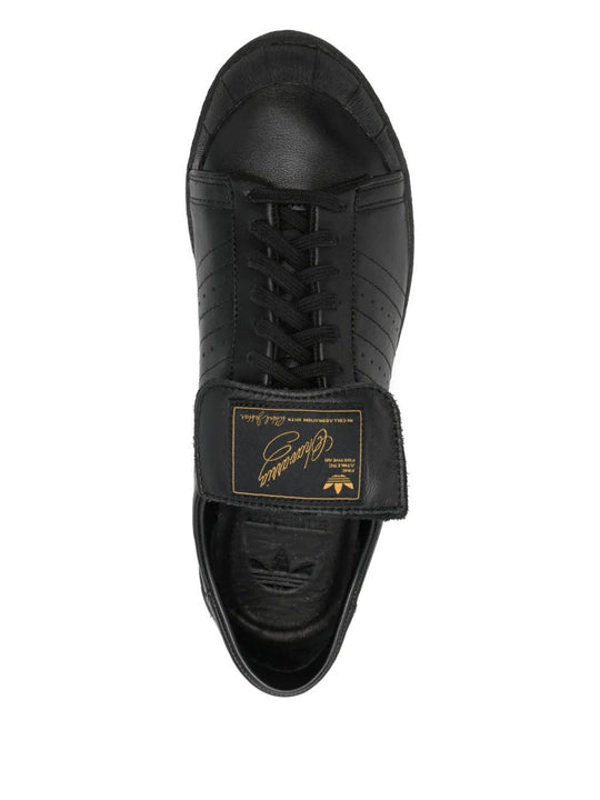 Close up of black shoes, showing texture of the rubber and calf leather fabric