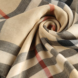 Close up of tan scarve, showing texture of the silk fabric