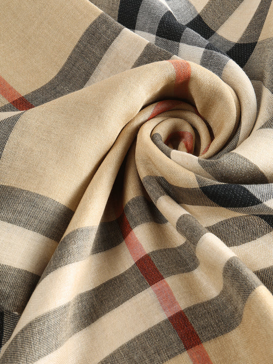 Close up of tan scarve, showing texture of the silk fabric