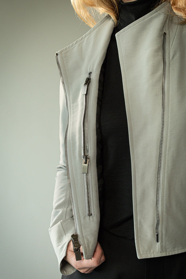 Close up of grey jacket, showing texture of the fabric
