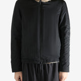 Black jacket worn by a person, showing the jacket fit