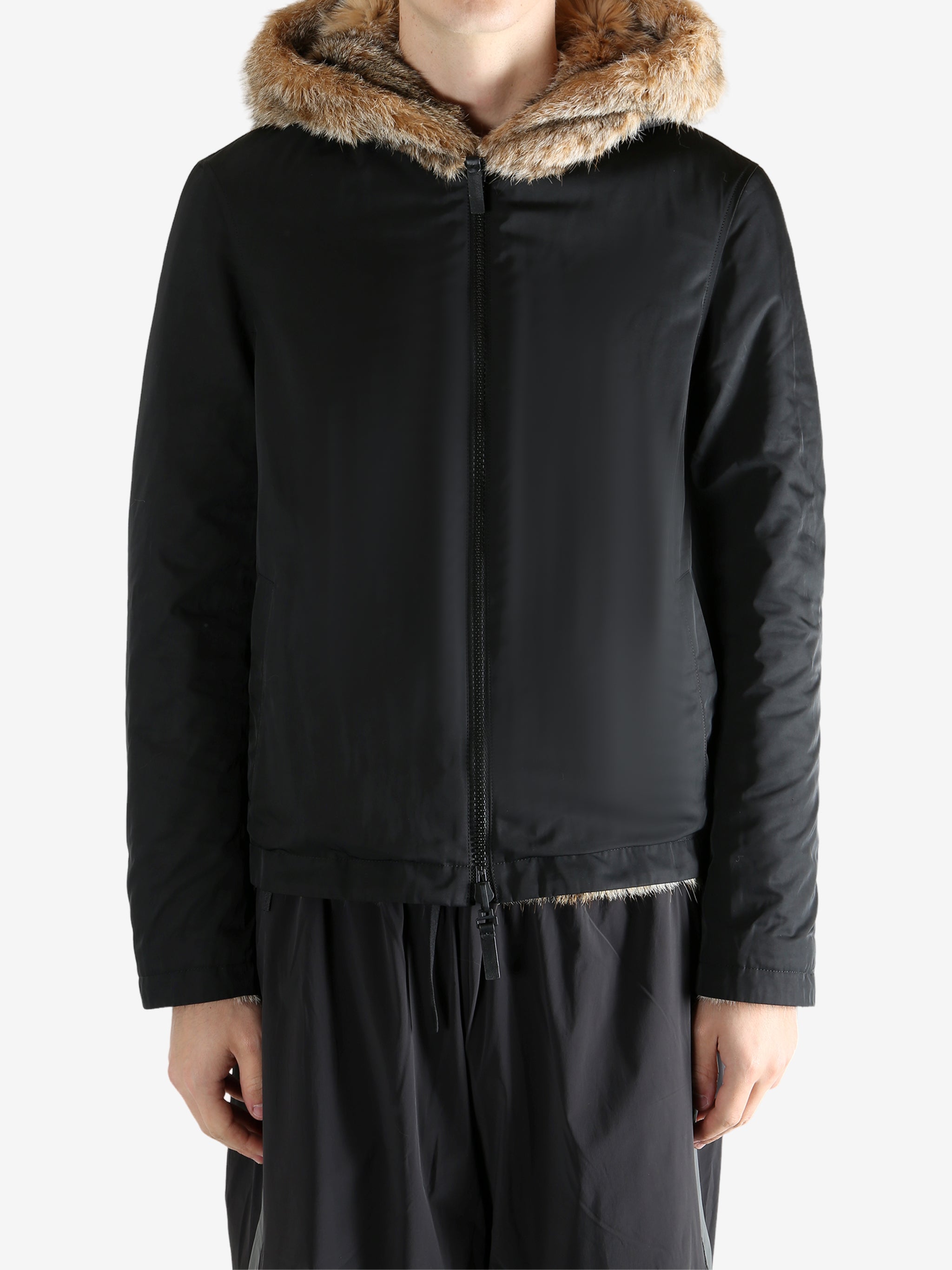 Black jacket worn by a person, showing the jacket fit