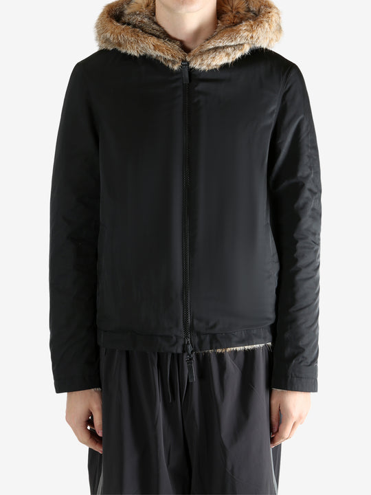 Black jacket worn by a person, showing the jacket fit