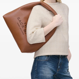 brown bags worn by a person, showing the bags fit