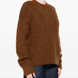 Brown sweater worn by a person, showing the sweater fit