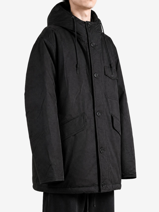 Black jacket worn by a person, showing the jacket fit