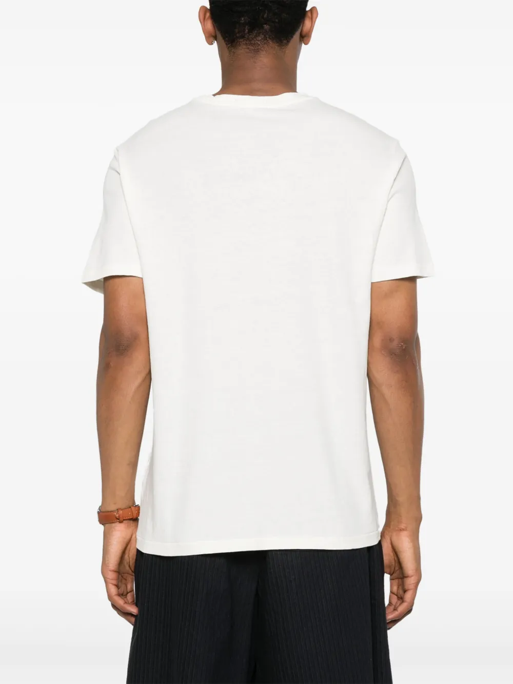 White t-shirt worn by a person, showing the shirt's fit