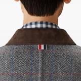 Close up of grey jacktes, showing texture of the calf leather and wool and cupro fabric