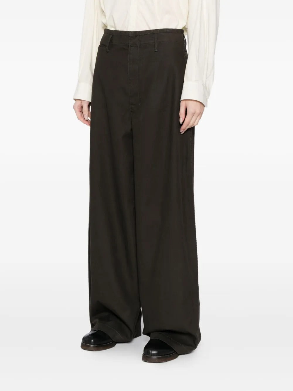 Black pants worn by a person, showing the pants' fit