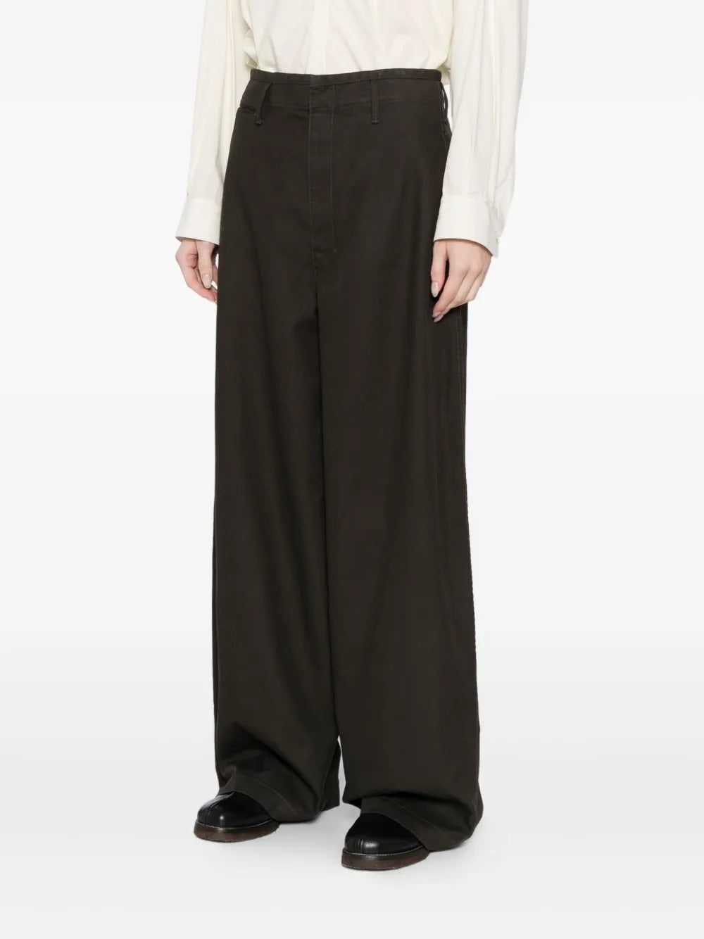 Black pants worn by a person, showing the pants' fit