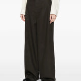 Black pants worn by a person, showing the pants' fit