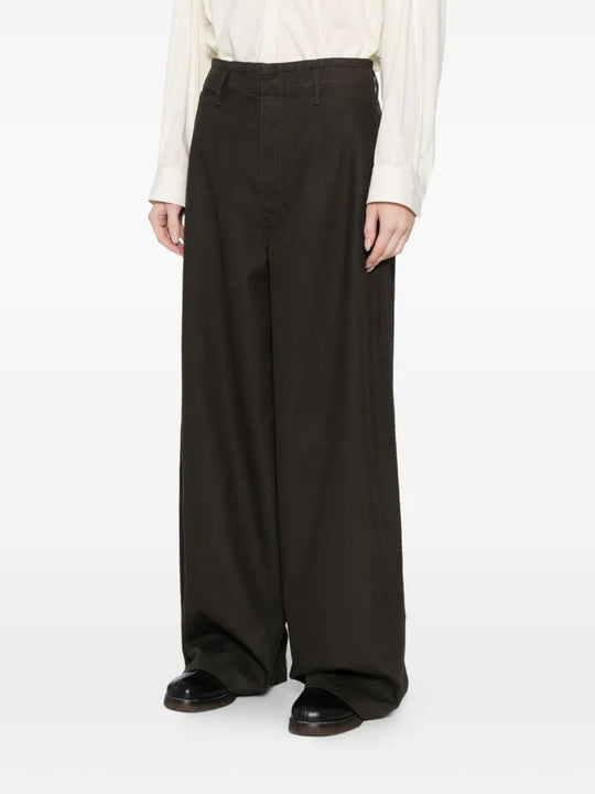 Black pants worn by a person, showing the pants' fit