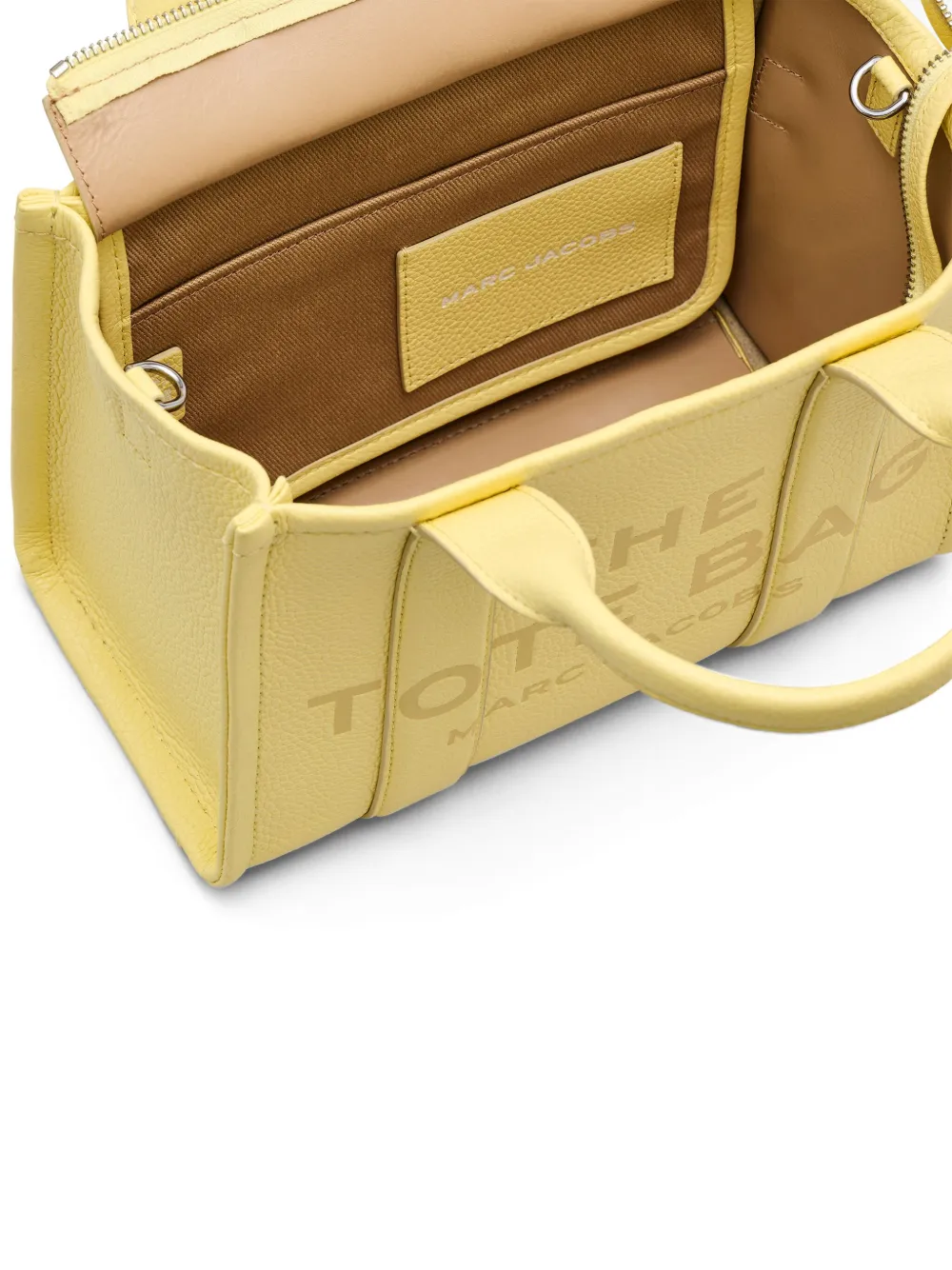 Close up of yellow bag, showing texture of the leather fabric