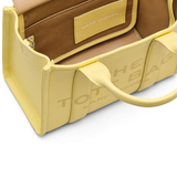 Close up of yellow bag, showing texture of the leather fabric