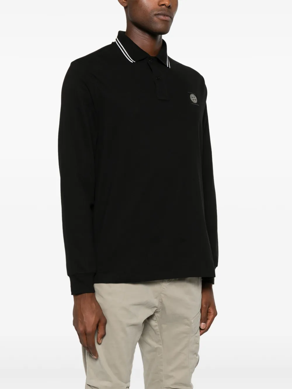 Black shirt worn by a person, showing the shirt's fit