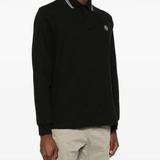 Black shirt worn by a person, showing the shirt's fit