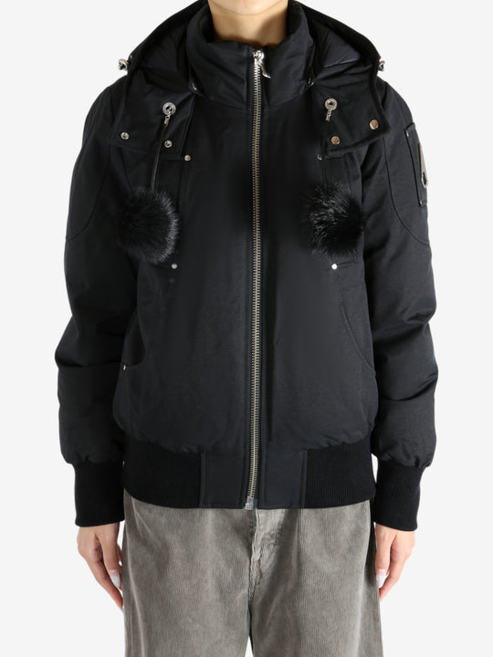 Black coat worn by a person, showing the coat fit