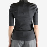 Grey tops worn by a person, showing the tops fit