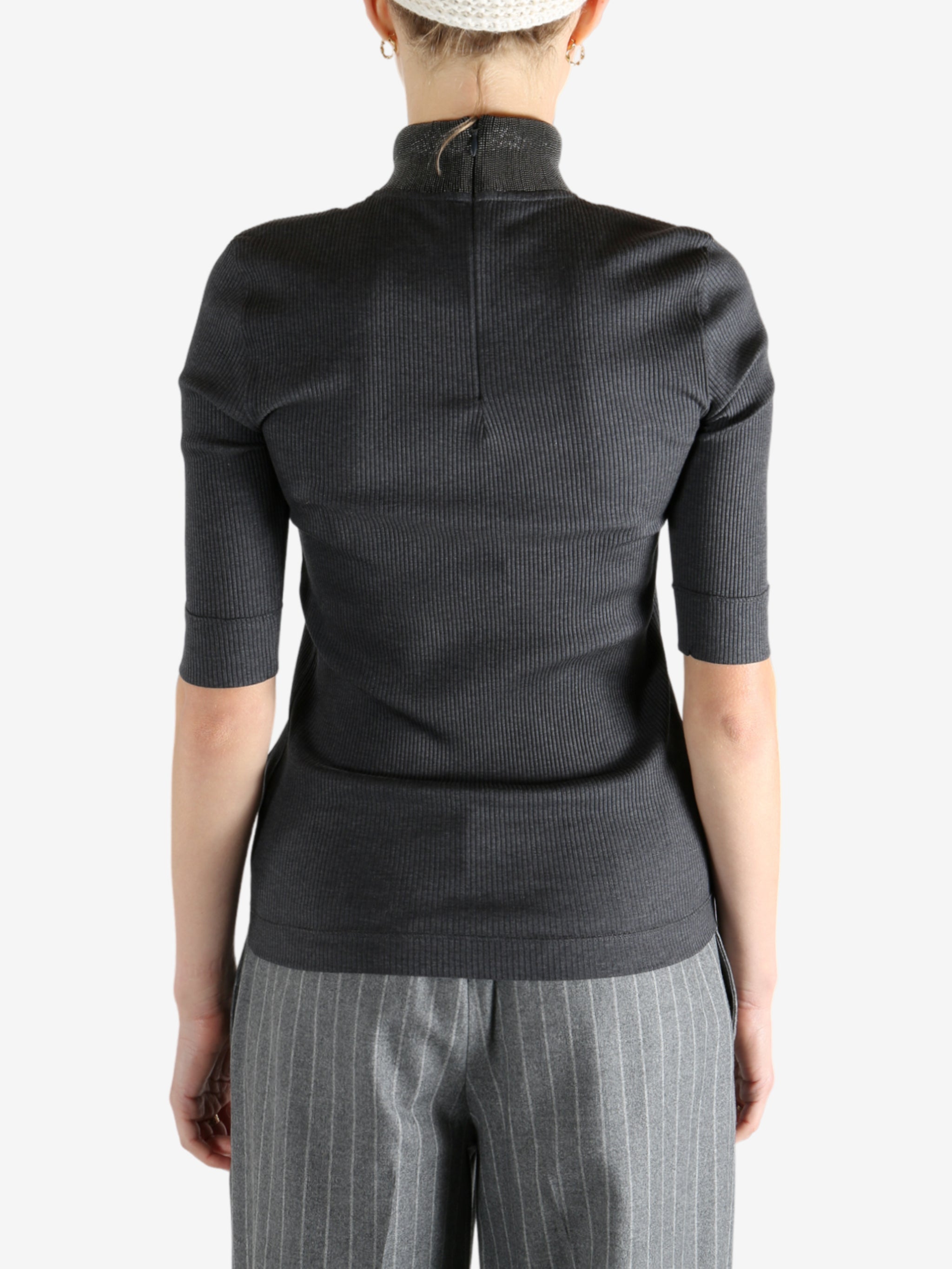 Grey tops worn by a person, showing the tops fit