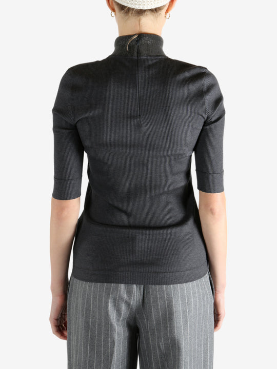 Grey tops worn by a person, showing the tops fit