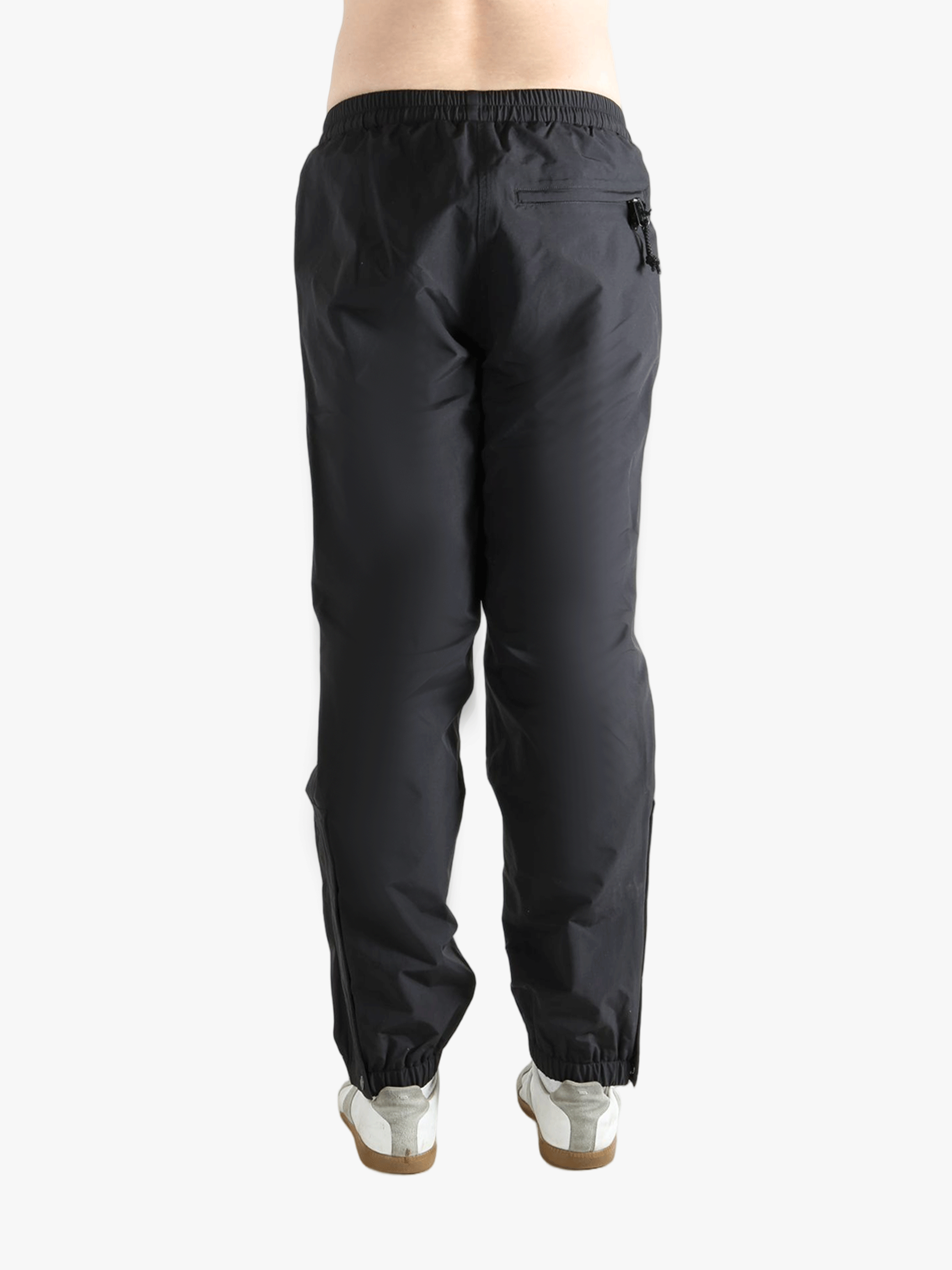 Black pants worn by a person showing the pants fit