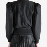 Black blouse worn by a person, showing the blouse's fit