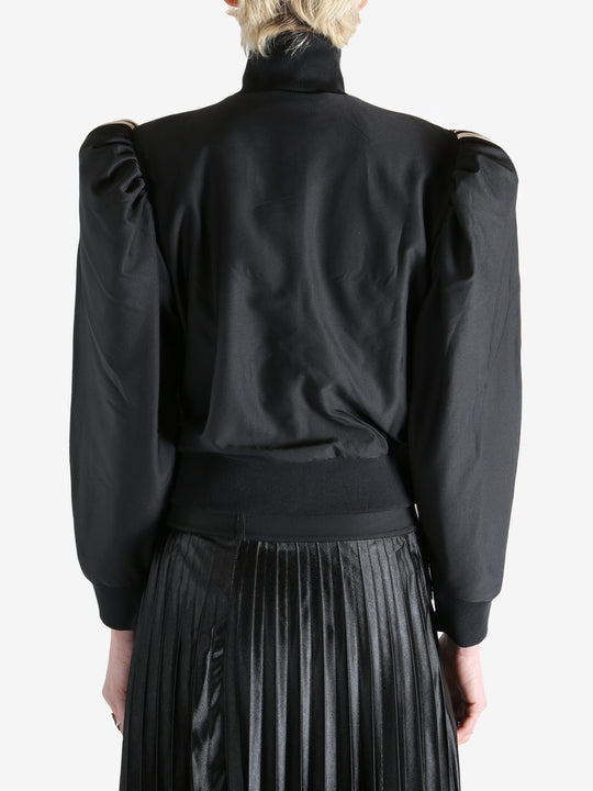 Black blouse worn by a person, showing the blouse's fit