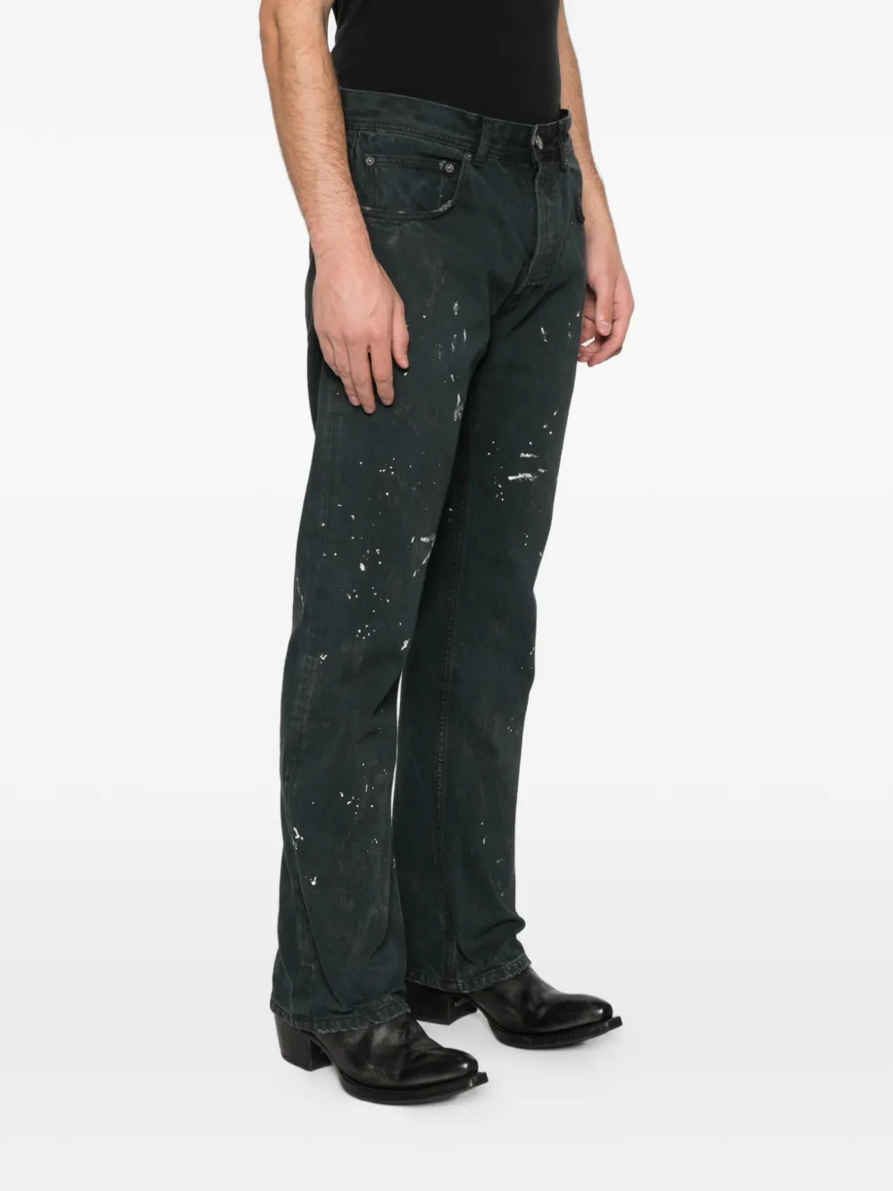 Black jeans worn by a person, showing the jeans fit