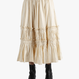 Beige tiered skirt worn by a person, showing the skirt fit