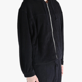 Black jackets worn by a person, showing the jackets fit