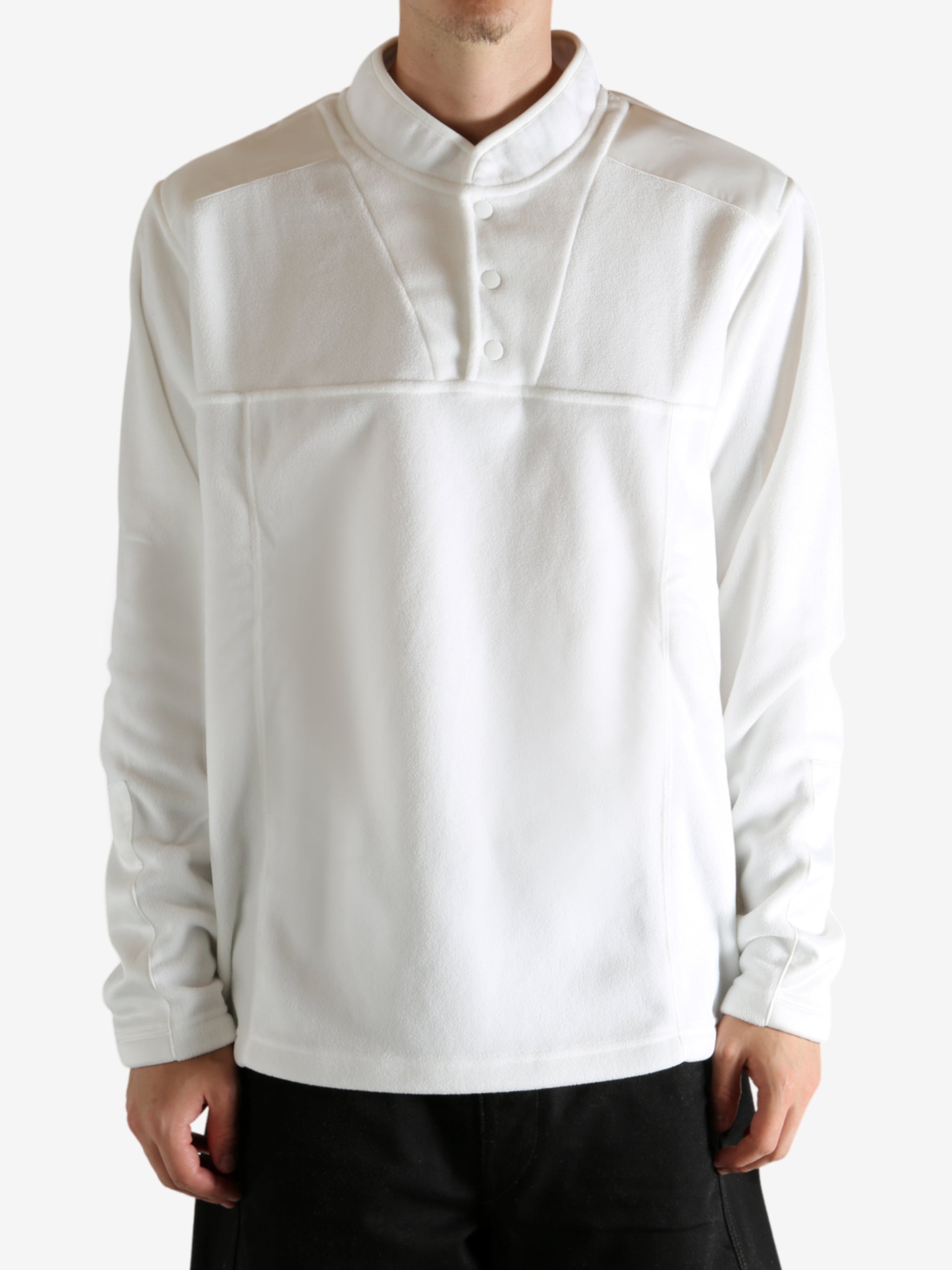 White sweatshirt worn by a person, showing the sweatshirt's fit