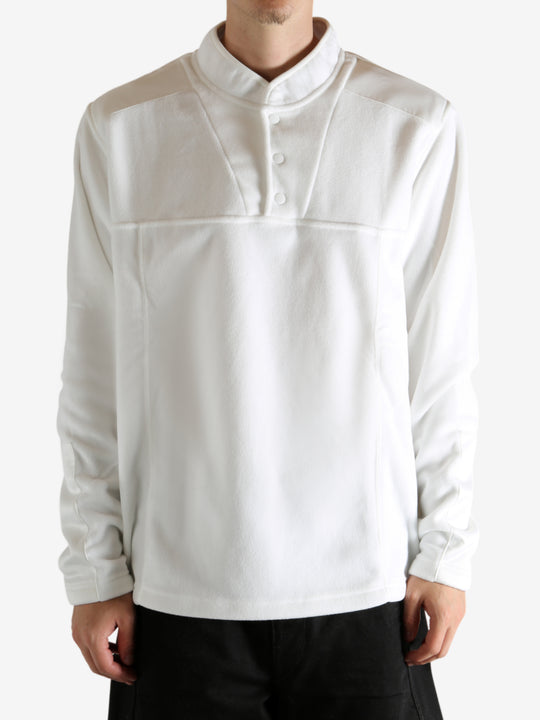 White sweatshirt worn by a person, showing the sweatshirt's fit