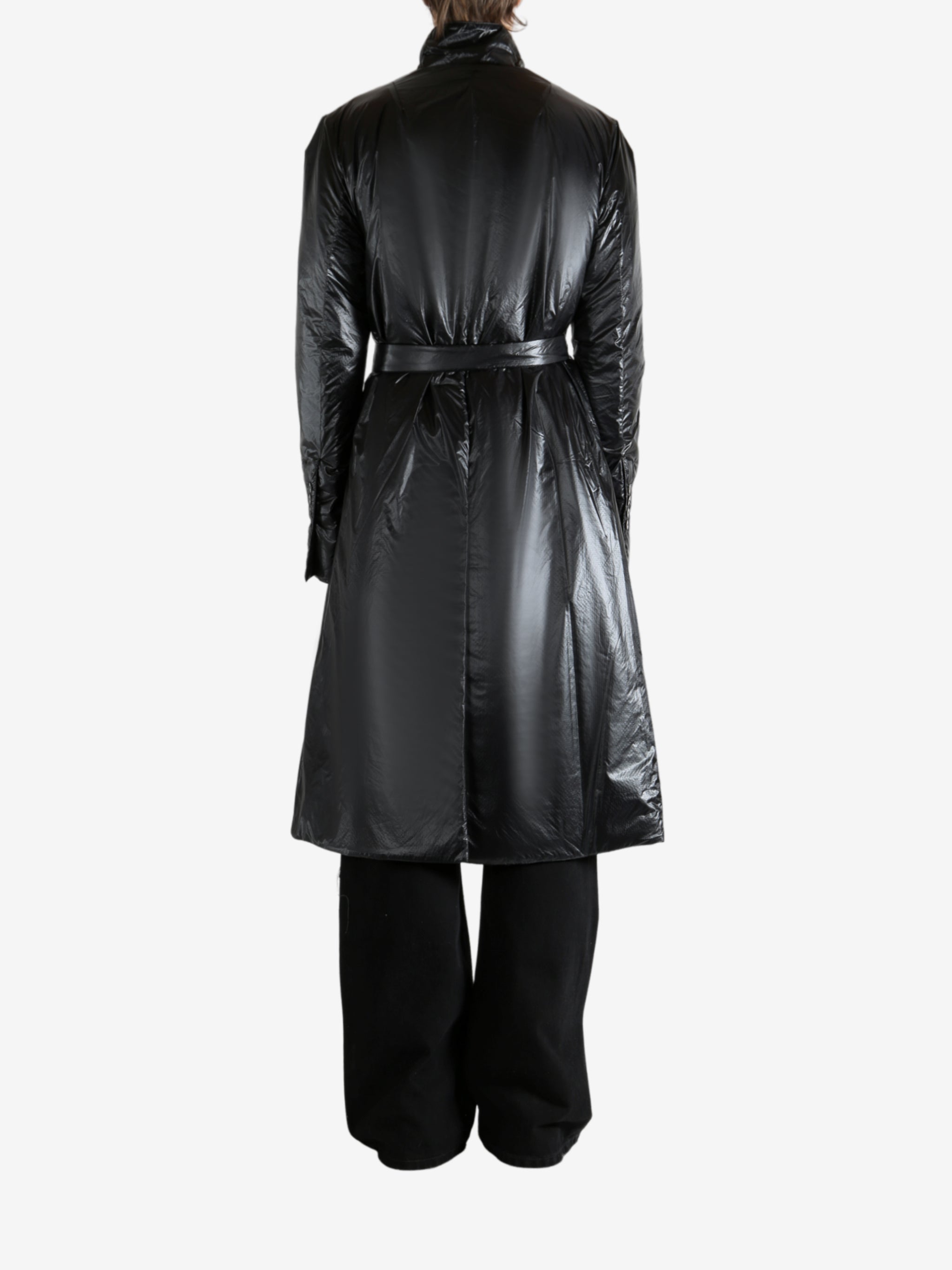 Black coat worn by a person, showing the coat's fit