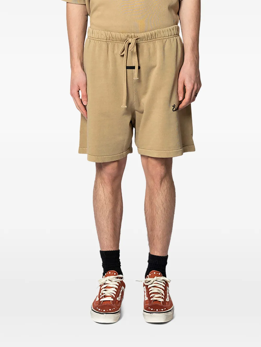 Tan shorts worn by a person, showing the shorts's fit