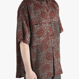 Grey shirt worn by a person, showing the shirt's fit