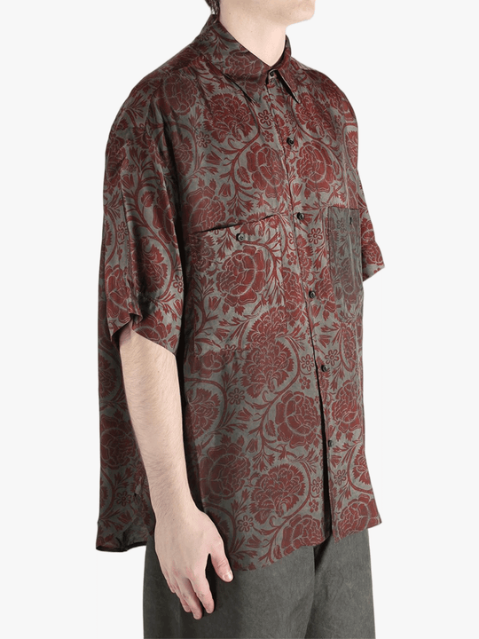 Grey shirt worn by a person, showing the shirt's fit