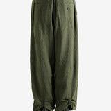 Green pants worn by a person, showing the pants' fit