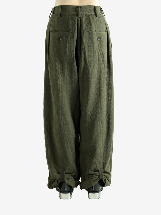 Green pants worn by a person, showing the pants' fit