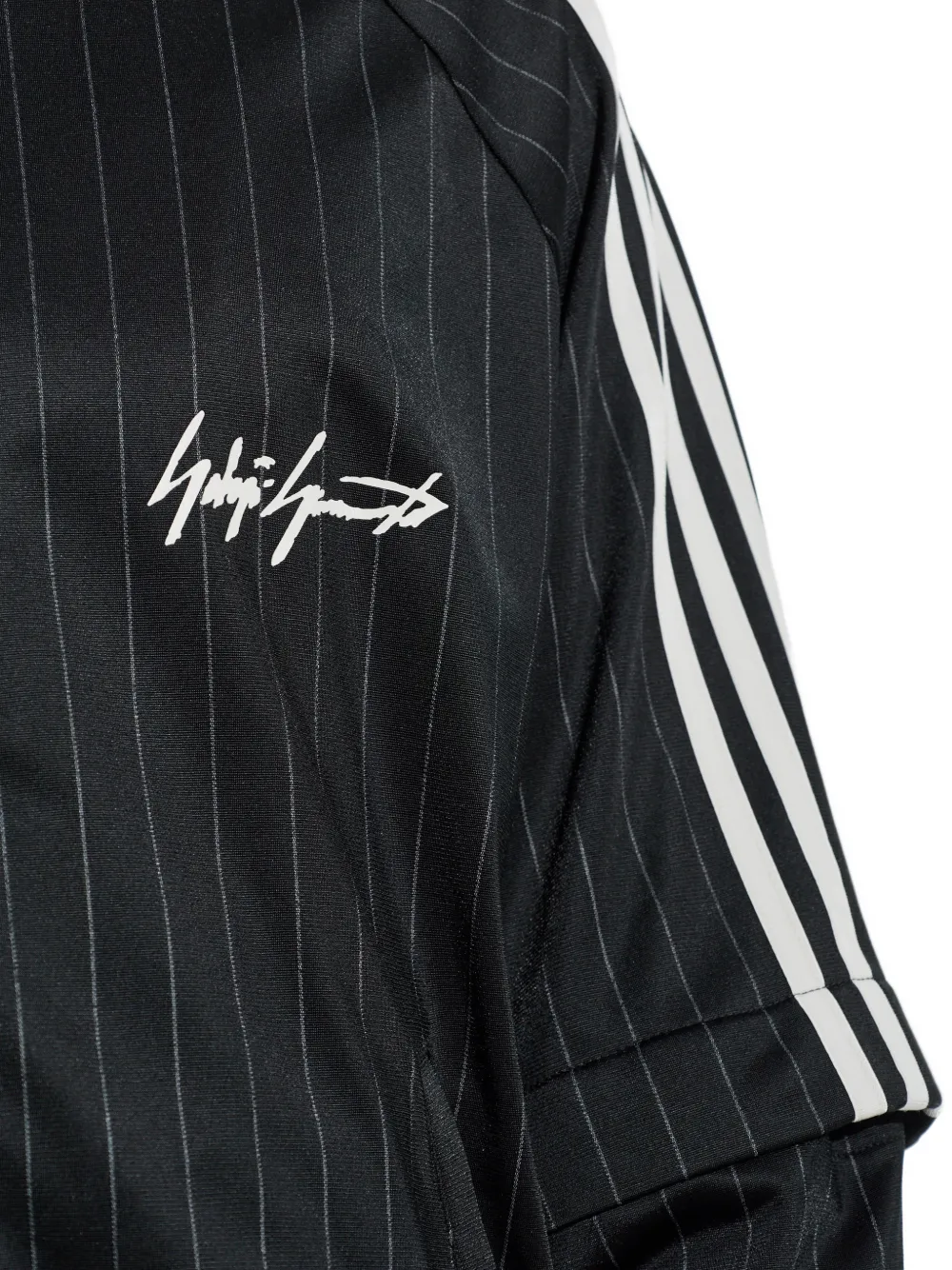 close up of black jackets-coats, showing texture of the recycled polyester fabric