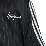 close up of black jackets-coats, showing texture of the recycled polyester fabric