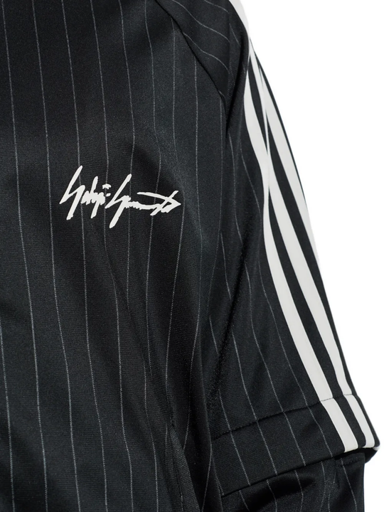 close up of black jackets-coats, showing texture of the recycled polyester fabric