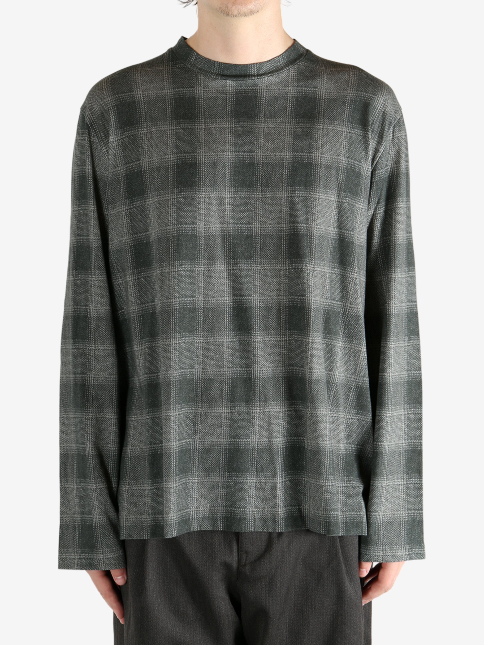 Grey shirt worn by a person, showing the shirt's fit