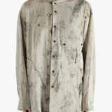 Grey shirt worn by a person, showing the shirt's fit