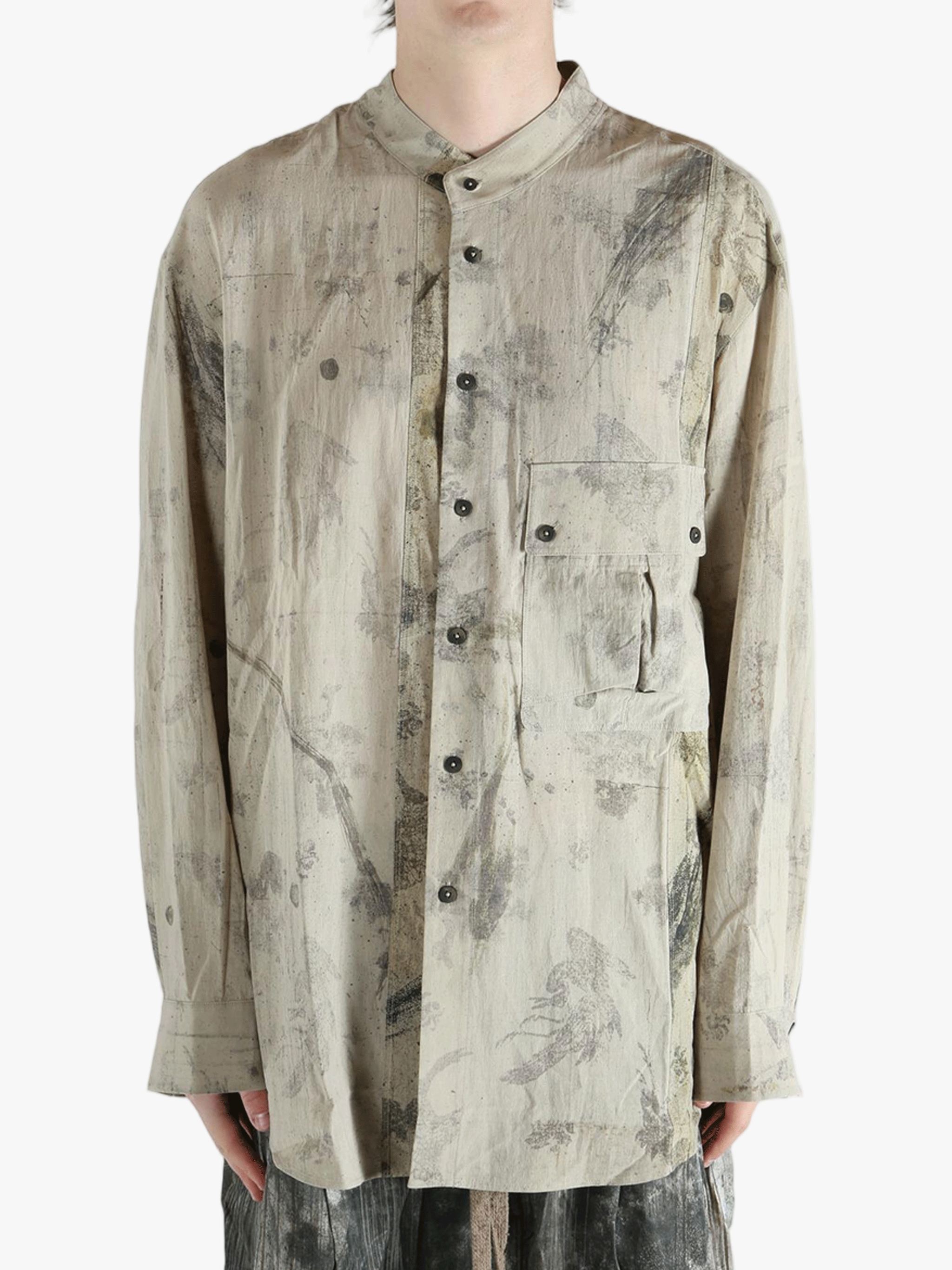 Grey shirt worn by a person, showing the shirt's fit