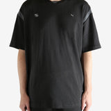 Black tee worn by a person, showing the tee"s fit