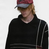 Red hat worn by a person, showing the hat's fit